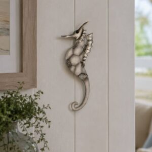 seahorse wall art with detailed metal and hand-painted white. 47x18cm