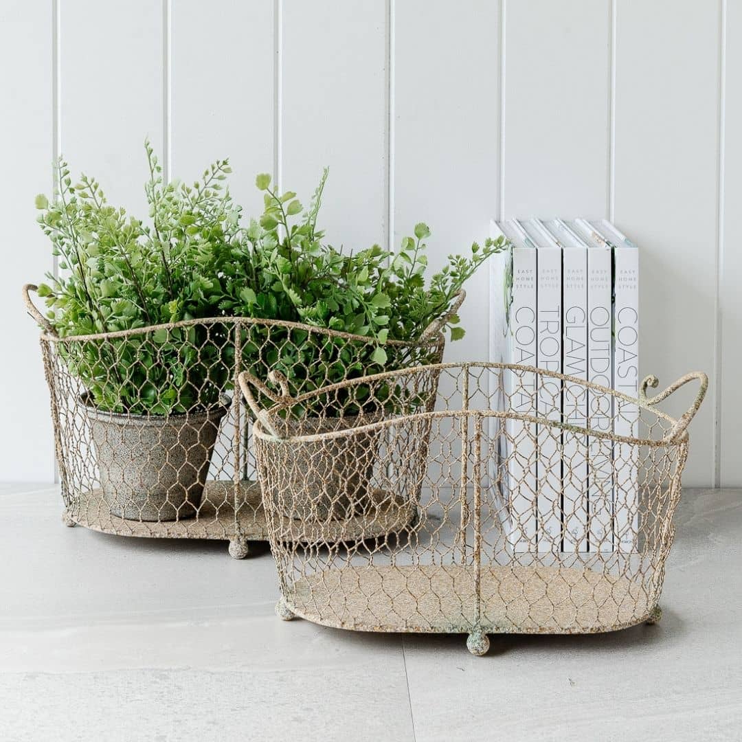 set of 2 oval wire baskets with handles, and a distressed rustic finish
